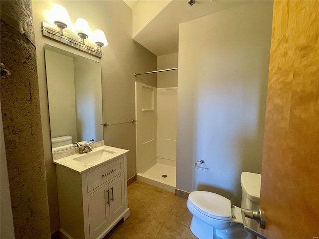 full bathroom featuring toilet, a shower, tile patterned flooring, and vanity