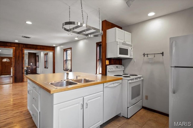 2013 Lily Ave, Saint Louis, MO 63122 - kitchen with white appliances, a peninsula, white cabinets, recessed lighting, and light countertops