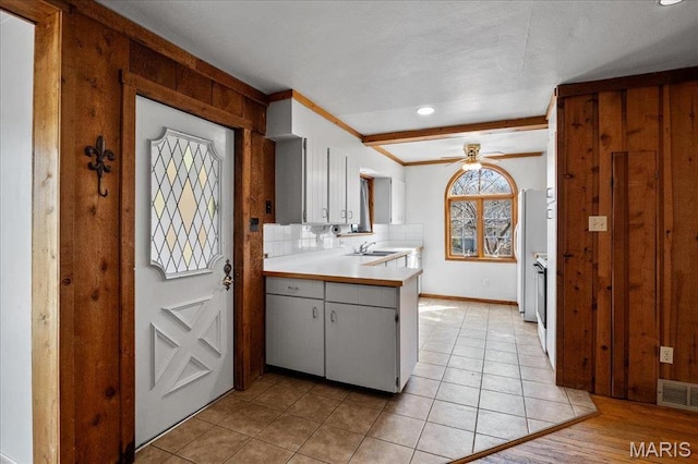 2013 Lily Ave, Saint Louis, MO 63122 - kitchen featuring ceiling fan, light countertops, crown molding, light tile patterned flooring, and decorative backsplash