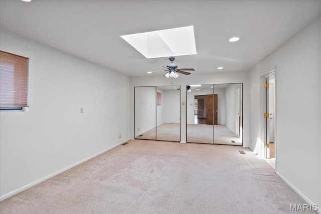2013 Lily Ave, Saint Louis, MO 63122 - unfurnished bedroom with a skylight, two closets, carpet, recessed lighting, and ceiling fan