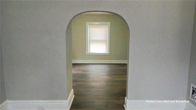 6522 Bartmer, University City, MO 63130 - hall with arched walkways, wood finished floors, and baseboards
