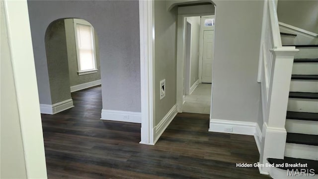 6522 Bartmer, University City, MO 63130 - hallway with arched walkways, wood finished floors, stairs, and a textured wall