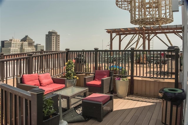 wooden deck featuring an outdoor hangout area, a pergola, and a city view