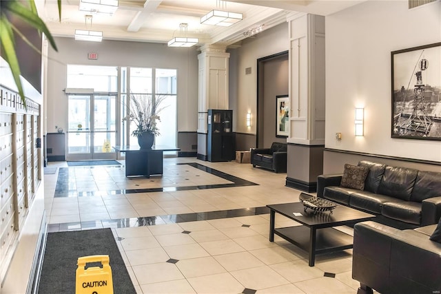 building lobby with beam ceiling, a high ceiling, coffered ceiling, and ornamental molding