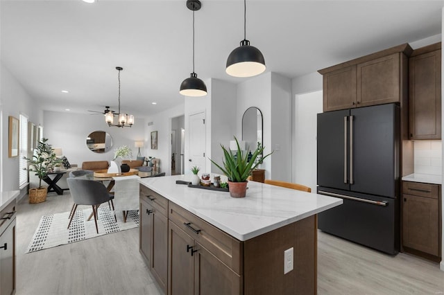 2543 Chukka Dr, Eureka, MO 63025 - kitchen featuring high quality fridge, light wood-style floors, decorative light fixtures, a center island, and recessed lighting