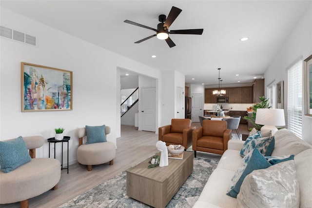 2543 Chukka Dr, Eureka, MO 63025 - living area featuring light wood finished floors, a chandelier, a ceiling fan, recessed lighting, and stairs