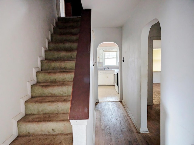 700 Pershing St E, St Louis, IL 62203 - staircase with arched walkways and wood-type flooring