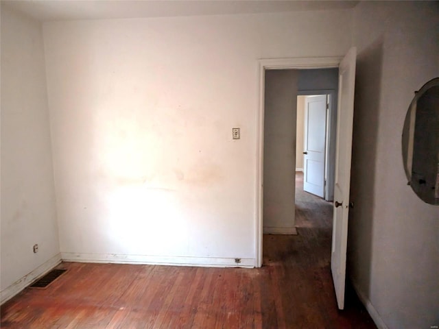 700 Pershing St E, St Louis, IL 62203 - spare room featuring wood finished floors and baseboards