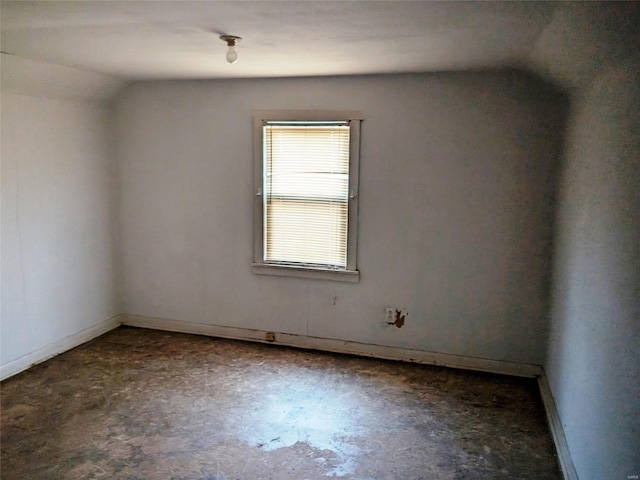 700 Pershing St E, St Louis, IL 62203 - empty room featuring lofted ceiling, unfinished concrete floors, and baseboards