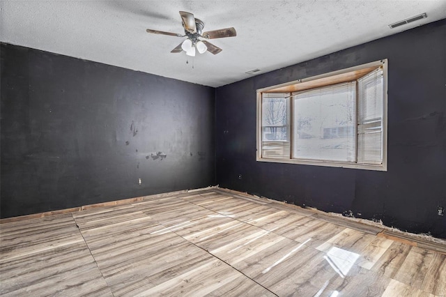8 Crescent Dr, Viburnum, MO 65566 - unfurnished room featuring a ceiling fan, a textured ceiling, and wood finished floors