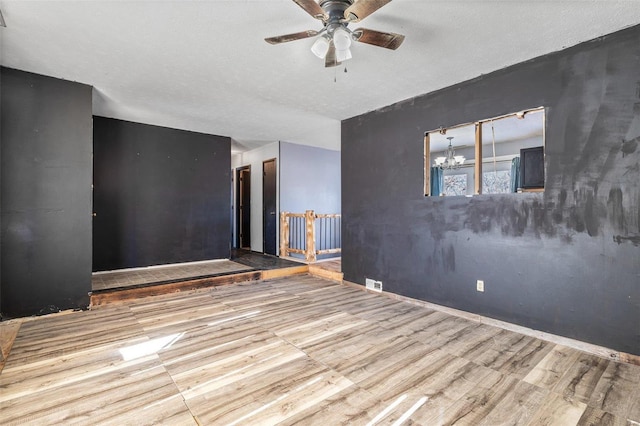 8 Crescent Dr, Viburnum, MO 65566 - unfurnished room featuring wood finished floors, ceiling fan, and a chandelier