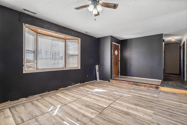 8 Crescent Dr, Viburnum, MO 65566 - unfurnished room featuring a textured ceiling, ceiling fan, and wood finished floors
