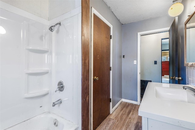 8 Crescent Dr, Viburnum, MO 65566 - full bath featuring wood finished floors, shower / bath combination, baseboards, vanity, and a textured ceiling