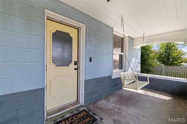 205 W 2nd St N, Wright City, MO 63390 - view of exterior entry with covered porch, crawl space, and fence