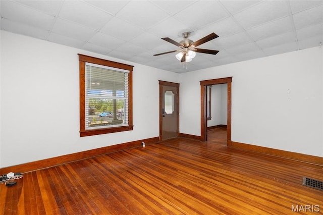 205 W 2nd St N, Wright City, MO 63390 - empty room featuring baseboards, a ceiling fan, hardwood / wood-style flooring, and a drop ceiling