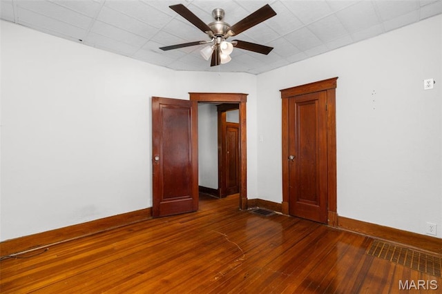 205 W 2nd St N, Wright City, MO 63390 - unfurnished bedroom with dark wood-style flooring, baseboards, and ceiling fan