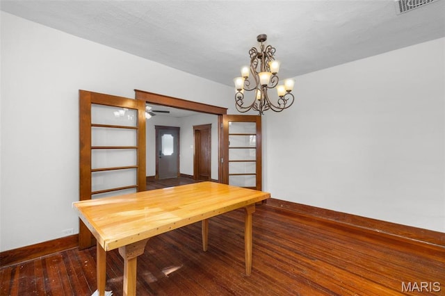205 W 2nd St N, Wright City, MO 63390 - dining area with dark wood-style flooring, a chandelier, and baseboards