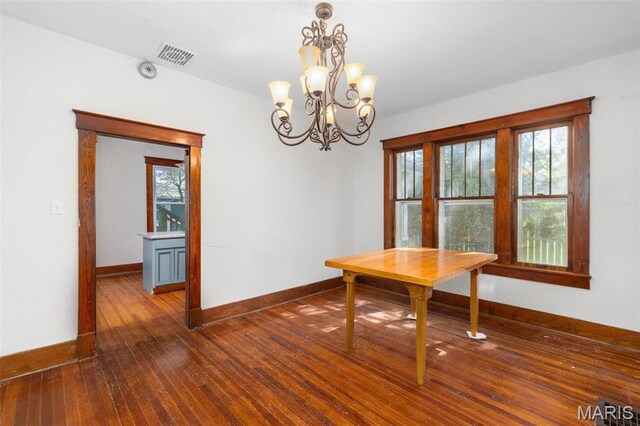 205 W 2nd St N, Wright City, MO 63390 - dining area with a chandelier, wood-type flooring, and baseboards