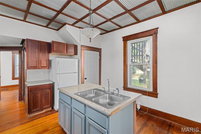 205 W 2nd St N, Wright City, MO 63390 - kitchen with a sink, baseboards, freestanding refrigerator, light wood-style floors, and light countertops