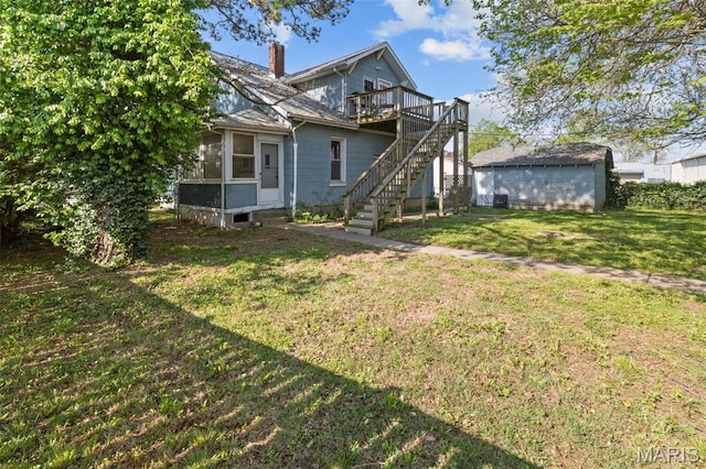 205 W 2nd St N, Wright City, MO 63390 - back of property with stairs, a chimney, a wooden deck, a lawn, and a sunroom