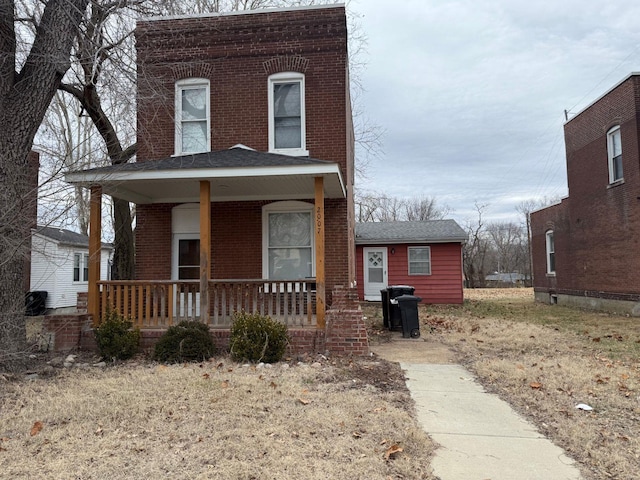view of front of property featuring a porch and brick siding