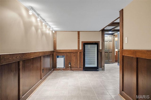 153 Bon Chateau Dr, Saint Louis, MO 63141 - empty room with rail lighting, light tile patterned flooring, and a wainscoted wall