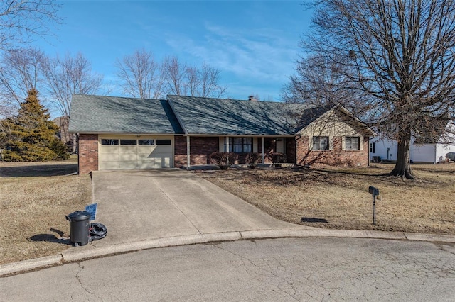 view of front of property with concrete driveway, a garage, and brick siding