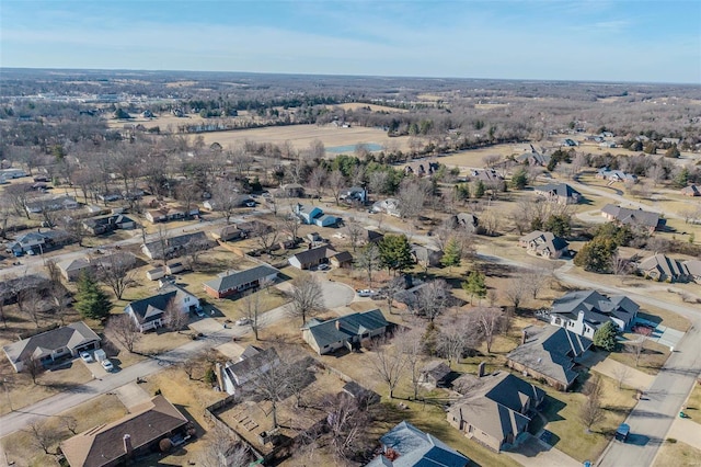 aerial view of property and surrounding area featuring nearby suburban area