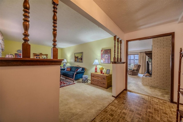 hall featuring carpet and a textured ceiling