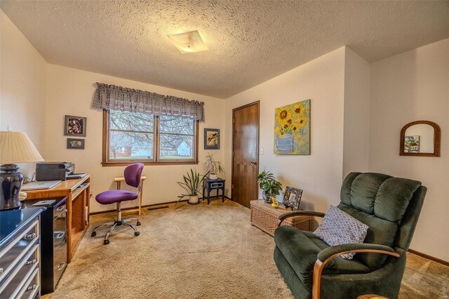 office featuring light carpet, a textured ceiling, and baseboards