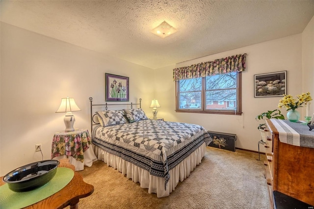 bedroom featuring light carpet, baseboards, and a textured ceiling
