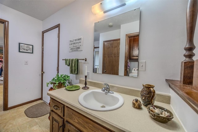bathroom with vanity and baseboards