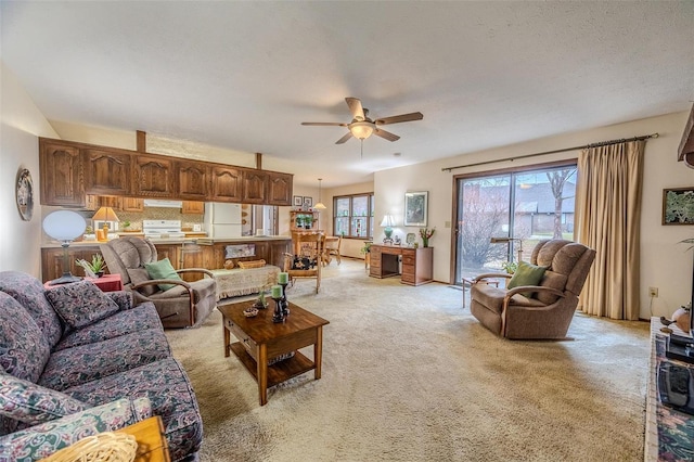 living area featuring a ceiling fan and light carpet