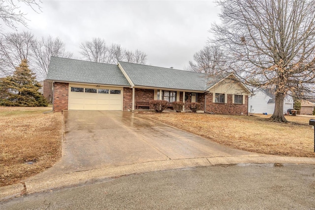 ranch-style house with a garage, brick siding, concrete driveway, and a front lawn
