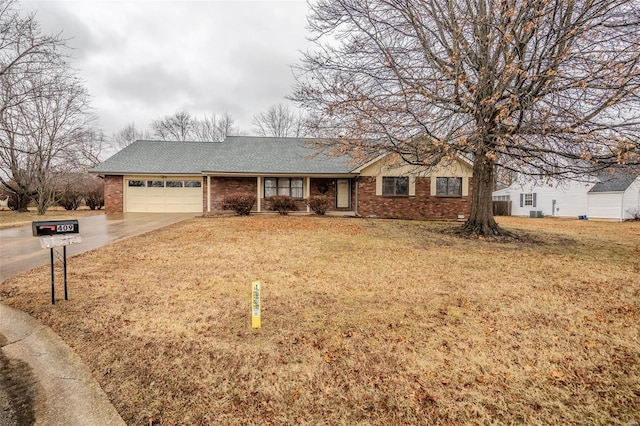 ranch-style home featuring brick siding, a garage, driveway, and roof with shingles