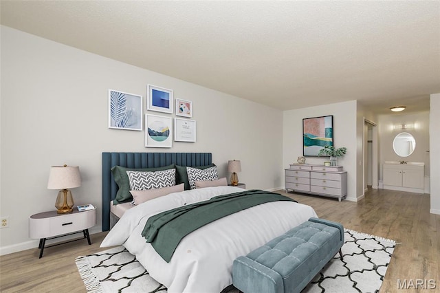 585 Coeur De Royale Dr Unit 201, Saint Louis, MO 63141 - bedroom with wood finished floors, baseboards, and ensuite bath