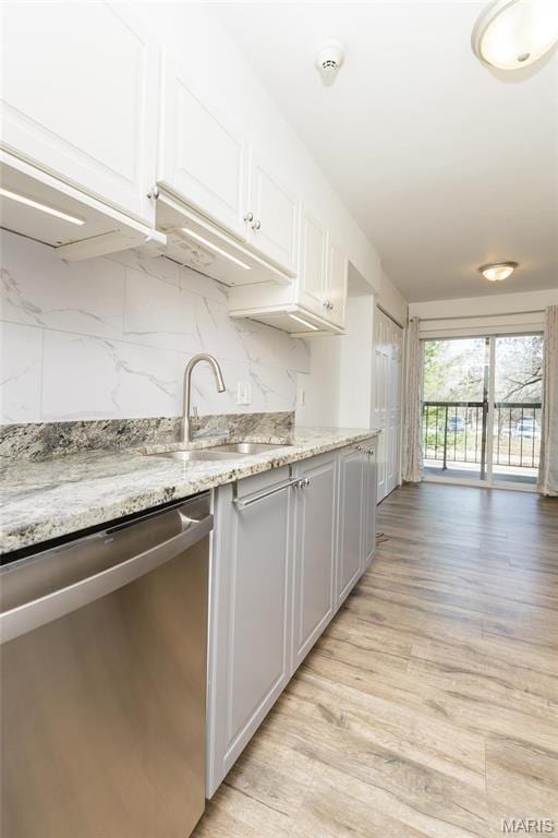585 Coeur De Royale Dr Unit 201, Saint Louis, MO 63141 - kitchen with dishwasher, a sink, white cabinetry, light wood-style flooring, and decorative backsplash