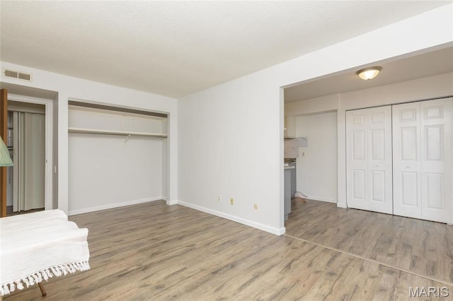 585 Coeur De Royale Dr Unit 201, Saint Louis, MO 63141 - unfurnished bedroom with wood finished floors and baseboards
