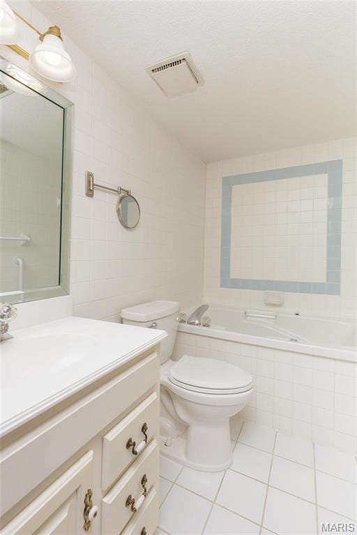 585 Coeur De Royale Dr Unit 201, Saint Louis, MO 63141 - full bathroom featuring tile walls, a relaxing tiled tub, tile patterned flooring, vanity, and toilet