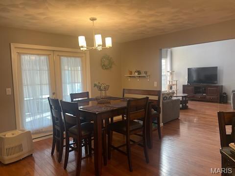 dining space featuring a chandelier and wood finished floors