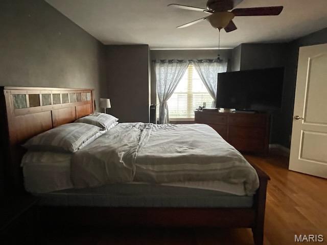 bedroom with wood finished floors and ceiling fan