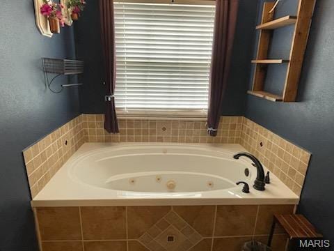 full bathroom with a whirlpool tub and a textured wall