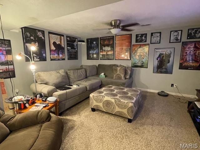 carpeted home theater featuring a ceiling fan and baseboards