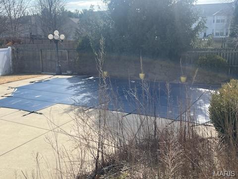 view of pool featuring fence and a patio area