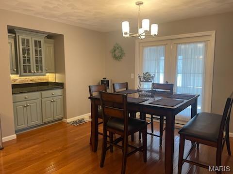 1212 Usher Dr, Ofallon, IL 62269 - dining space with a chandelier, baseboards, and wood finished floors