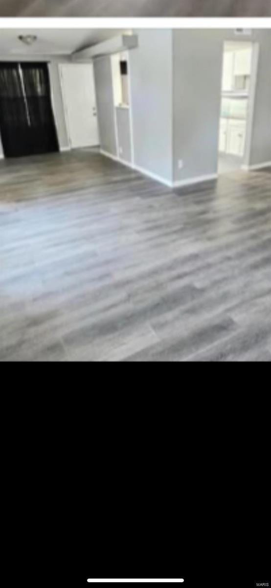805 Derhake Rd, Florissant, MO 63033 - unfurnished living room with baseboards
