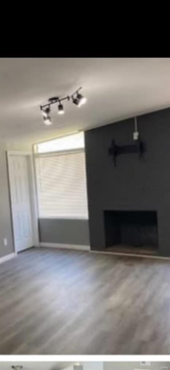805 Derhake Rd, Florissant, MO 63033 - unfurnished living room featuring a fireplace and baseboards