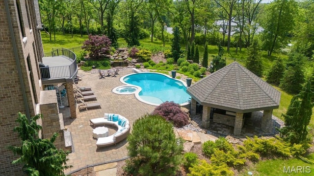 2535 S Lindbergh Blvd, Saint Louis, MO 63131 - view of pool featuring a gazebo, a patio, a pool with connected hot tub, view of wooded area, and an outdoor fire pit