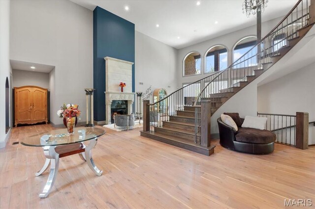2535 S Lindbergh Blvd, Saint Louis, MO 63131 - living room featuring a high ceiling, wood finished floors, a fireplace, stairs, and recessed lighting