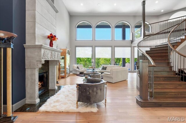 2535 S Lindbergh Blvd, Saint Louis, MO 63131 - living area featuring stairway, a fireplace, wood finished floors, recessed lighting, and a towering ceiling